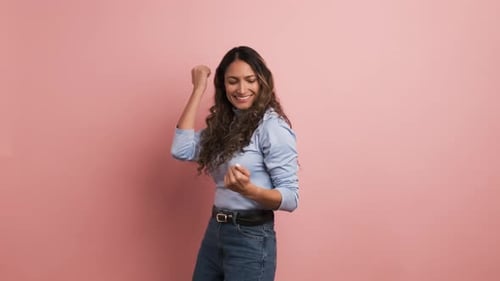 Cheerful Woman Dancing and Celebrating in Studio