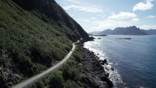 Cars driving on a famous Norwegian costal road during summer in Northern Norway, Aerial forwarding s