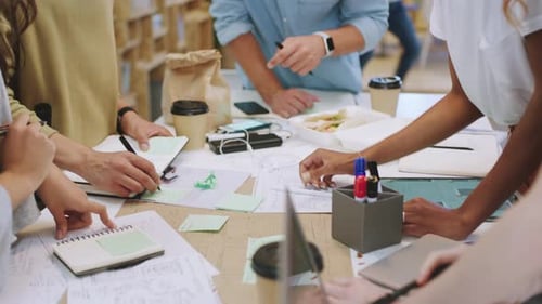 Hands, teamwork and planning with design or business people working as a team in a startup office