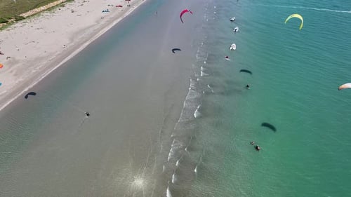 Aerial view of kitesurfers in water, Italy.