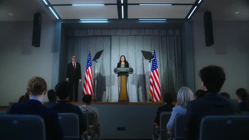 Woman Giving Speech at Podium with American Flags