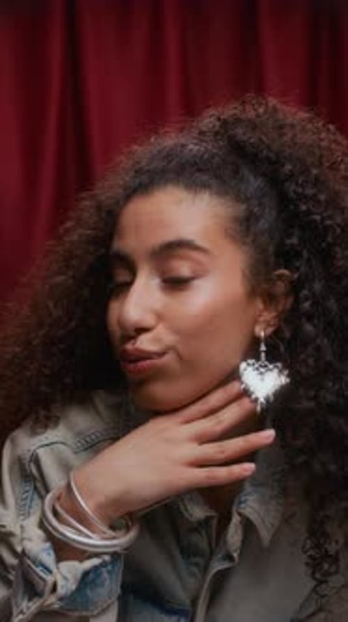 Playful Biracial Woman with Teethy Smile Striking Pose in Photo Booth