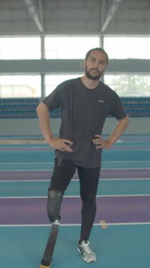 Confident Man With Prosthetic Leg in Stadium