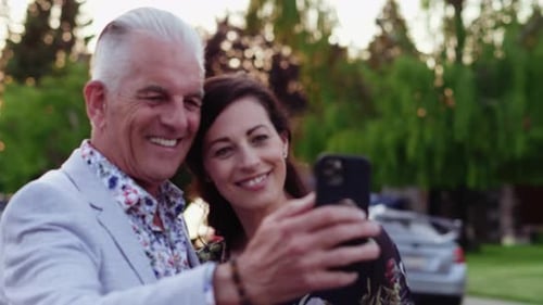 Affectionate Couple Smiling for Smartphone Selfie Outdoors