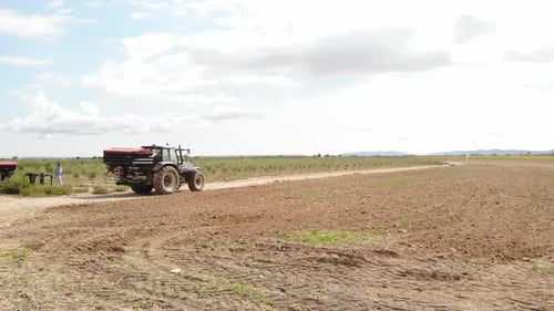 Tractor Driving Through a Rural Field