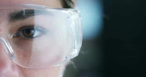 Woman Wearing Safety Goggles in Laboratory Setting Close Up