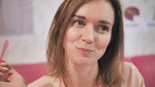 Woman Eating Dessert and Smiling