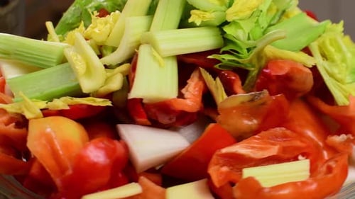 Close up of fresh chopped vegetables rotating with red chili peppers