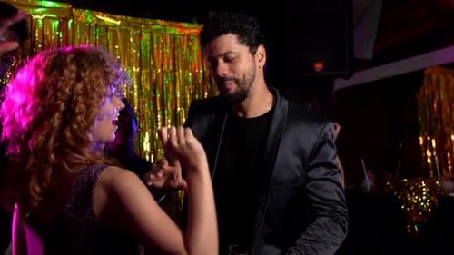 People Celebrating and Dancing Together in Nightclub