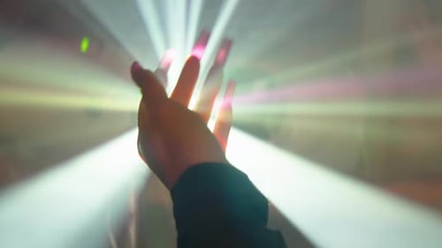 Hand Reaching in Bright Abstract Light
