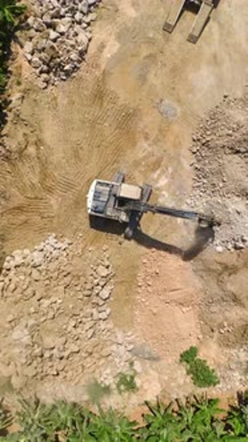 Vertical Video Housing Grounds Aerial Insight Into Tractor Preparing Land for Residential Complex