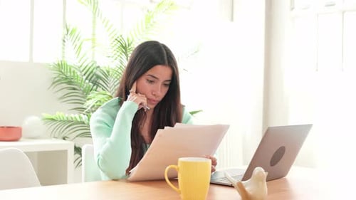 Young Woman Getting Up From Table After Working