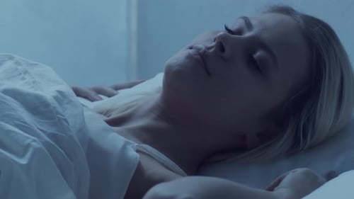 Woman Sleeping Peacefully in Bed at Night