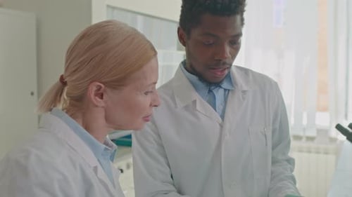 Scientists Collaborate on Research in a Medical Laboratory