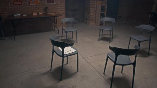 Chairs Set Up in Circle in Prison Hall for Group Therapy Session