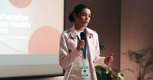 Confident Woman Giving Wellness Presentation at Conference