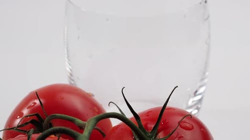Tomato juice is poured into a glass.