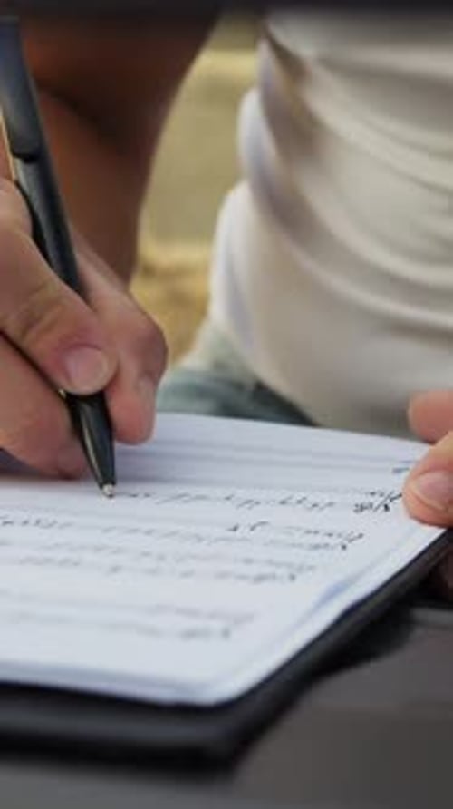 Hand writing on a piece of paper