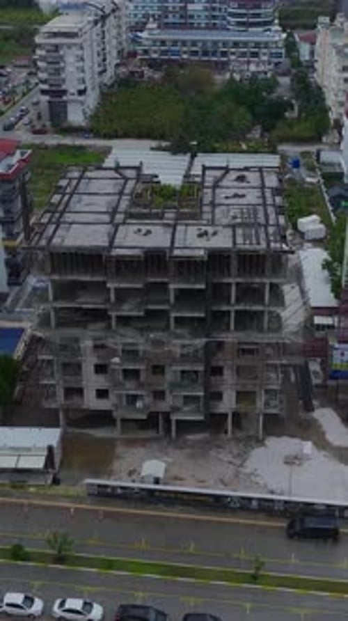 Vertical Video Construction Workers Using Tools and Operating Heavy Equipment on Site Captured