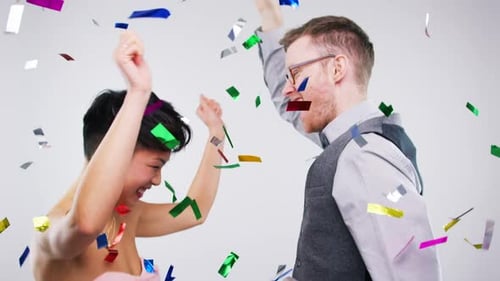 Disco dance, confetti and couple in studio having fun isolated on a gray background