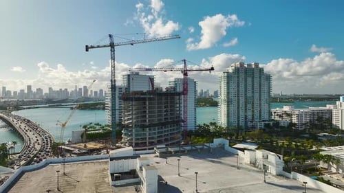 Tower Lifting Cranes at High Residential Apartment Building Construction Site Real Estate