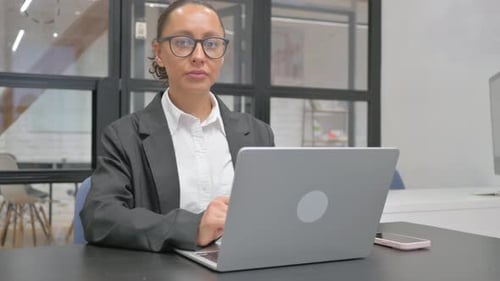 Woman Working on Laptop in Modern Office