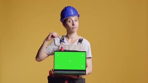 Portrait of Handywoman Holding Laptop with Greenscreen Display