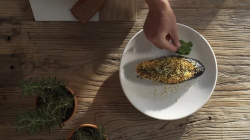 Perfectly cooked salmon fillet served on a white plate with fresh parsley and topped with golden lem