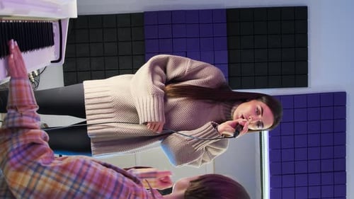 Woman Sings in Recording Studio with Piano