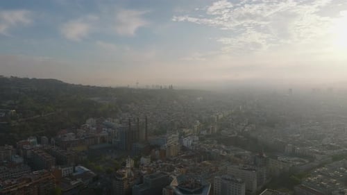 Aerial Descending Footage of Metropolis at Sunset Revealing Top of Office Skyscraper Barcelona Spain