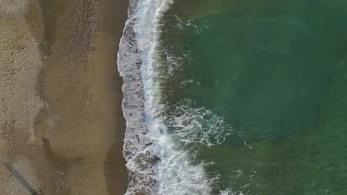 Calm Coastline Aerial of Stone Pier and Empty Beach