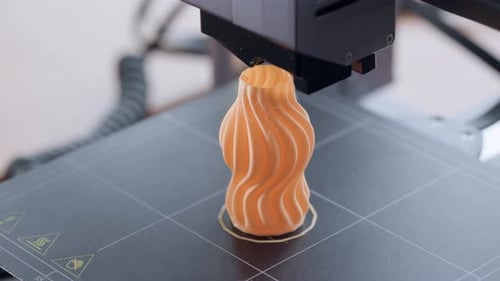 3D Printer, 3D Printing orange object. 4.0 industrial revolution. Extreme Close Up.