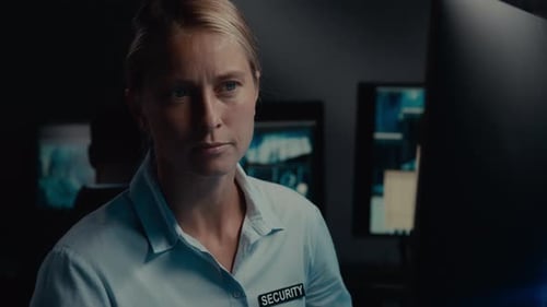 Woman in Security Uniform Working at Computer