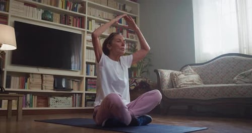 Senior Woman Practicing Yoga at Home in Living Room