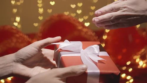 Exchanging a Beautifully Wrapped Gift with a White Bow