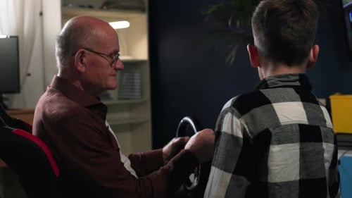 Senior Man Learns Gaming from Child at Home