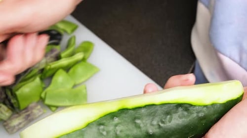 Close Up View of Female Hands Peeling a Cucumber with a Vegetable Peeler Concept of Healthy Eating
