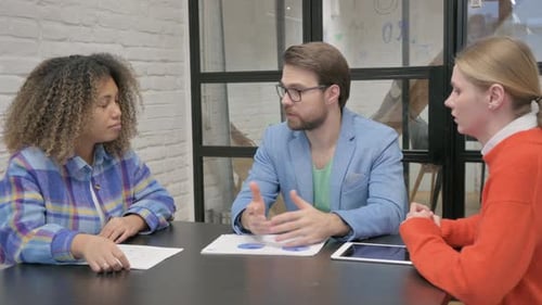 Business Team Discussing Charts and Graphs in Office