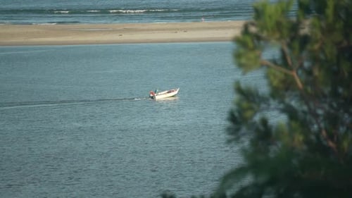 Boat Moving Through Calm Water on a Sunny Day