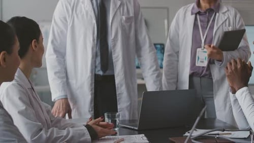 Doctors in White Coats Clapping at Meeting