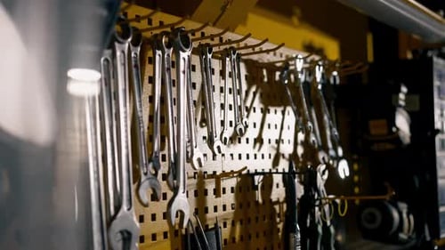 In a Motorcycle Repair Shop Various Tools for Repairing Motorbikes Hang on a Yellow Wall Master