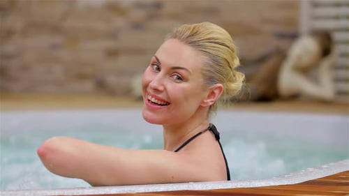 Radiant Woman Enjoying a Blissful Soak in a Hot Tub