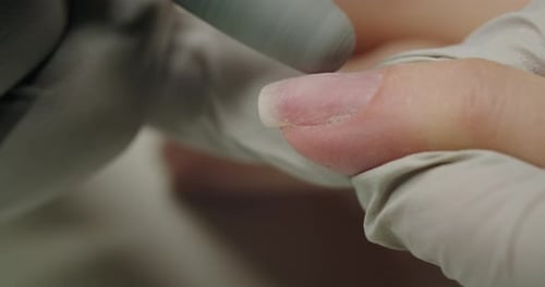 Woman on Hand Care Procedure in Nail Salon