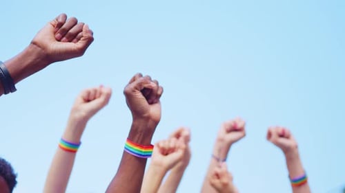 Cropped Image of People Raising Arms with Close Fists Wearing a Lgbt Bracelet