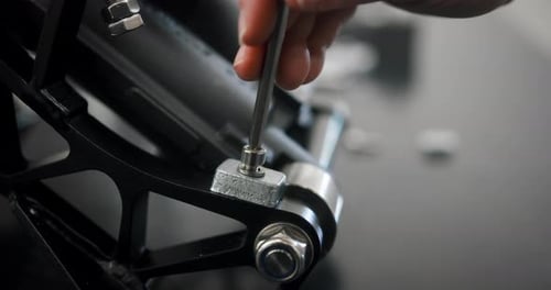 Tightening a bolt during the assembly of a new engine. Close-up view.