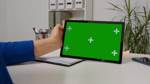 Close up chorma key horizontal tablet screen used by female worker.