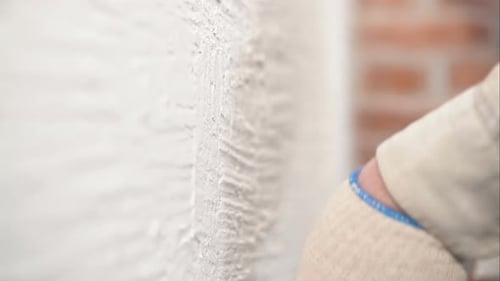 Spreading Plaster on a Brick Wall with Spatula