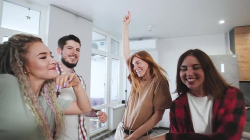 Friends and Family Dancing Together at Home
