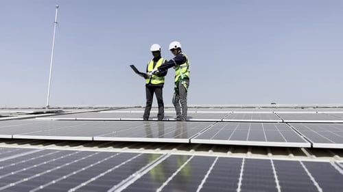 Technician installing solar cell. Installation and maintenance of solar cells on rooftop.