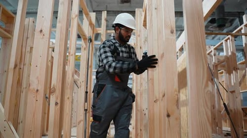 Indian Carpenter Assembling Wooden Frame at Modular Home Factory